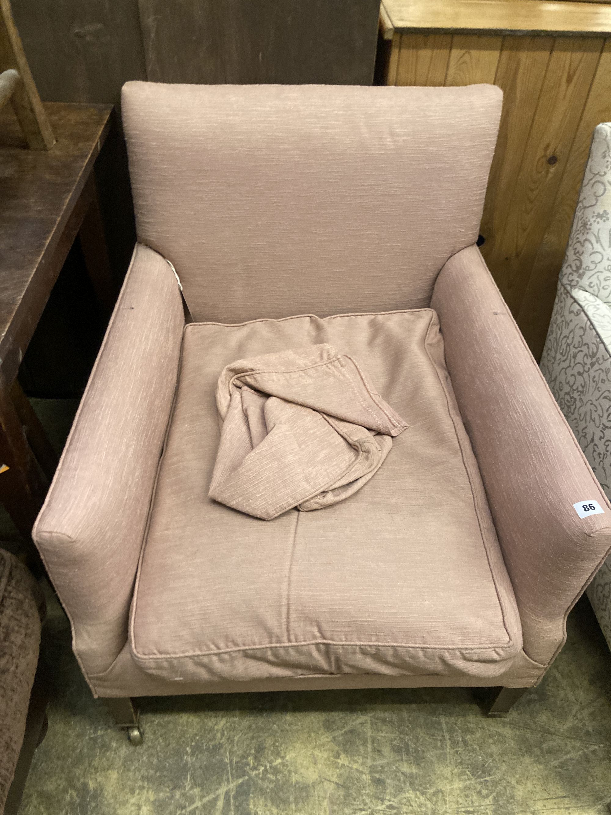A pair of Edwardian Howard & Son upholstered square framed armchairs with stamped legs and casters, width 69cm, depth 70cm, height 78cm
